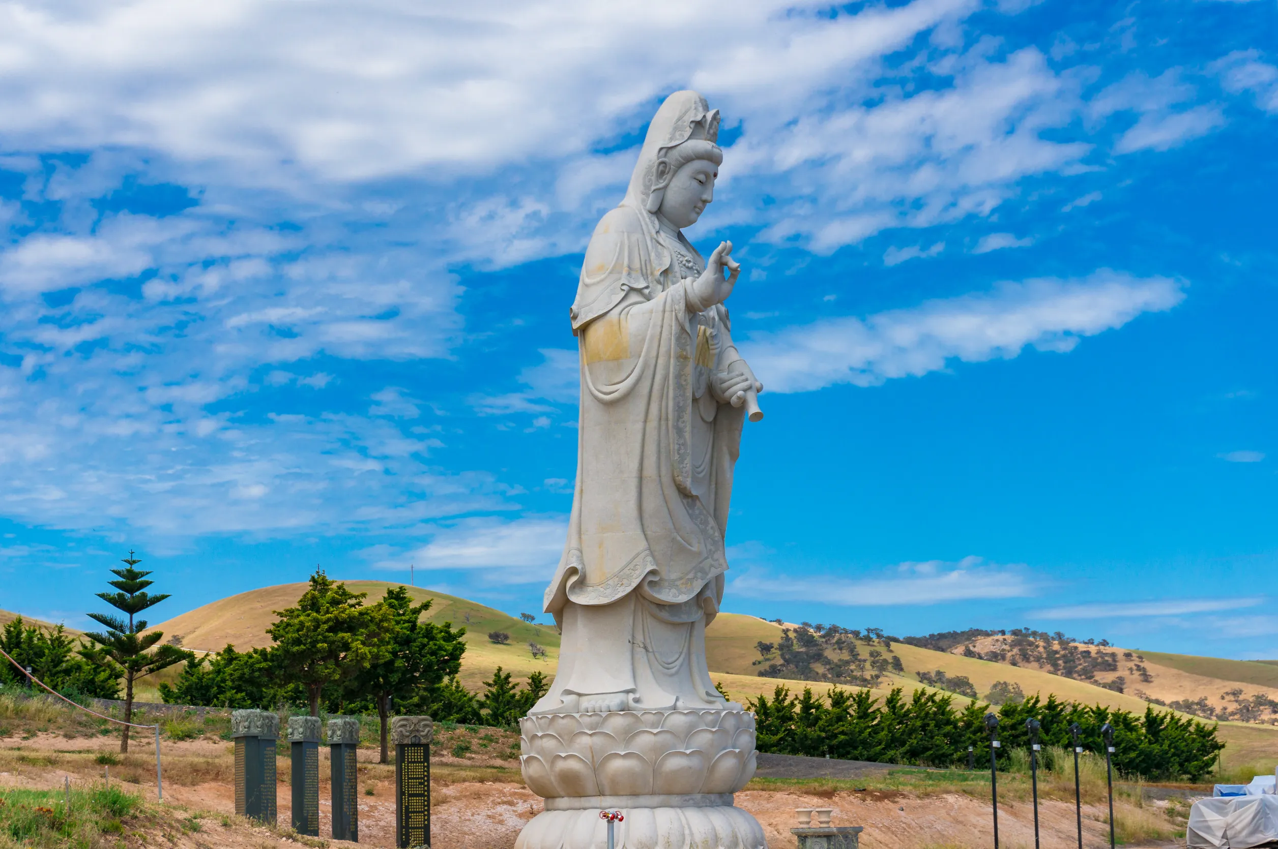 giant female buddha statue in picturesque surroundings