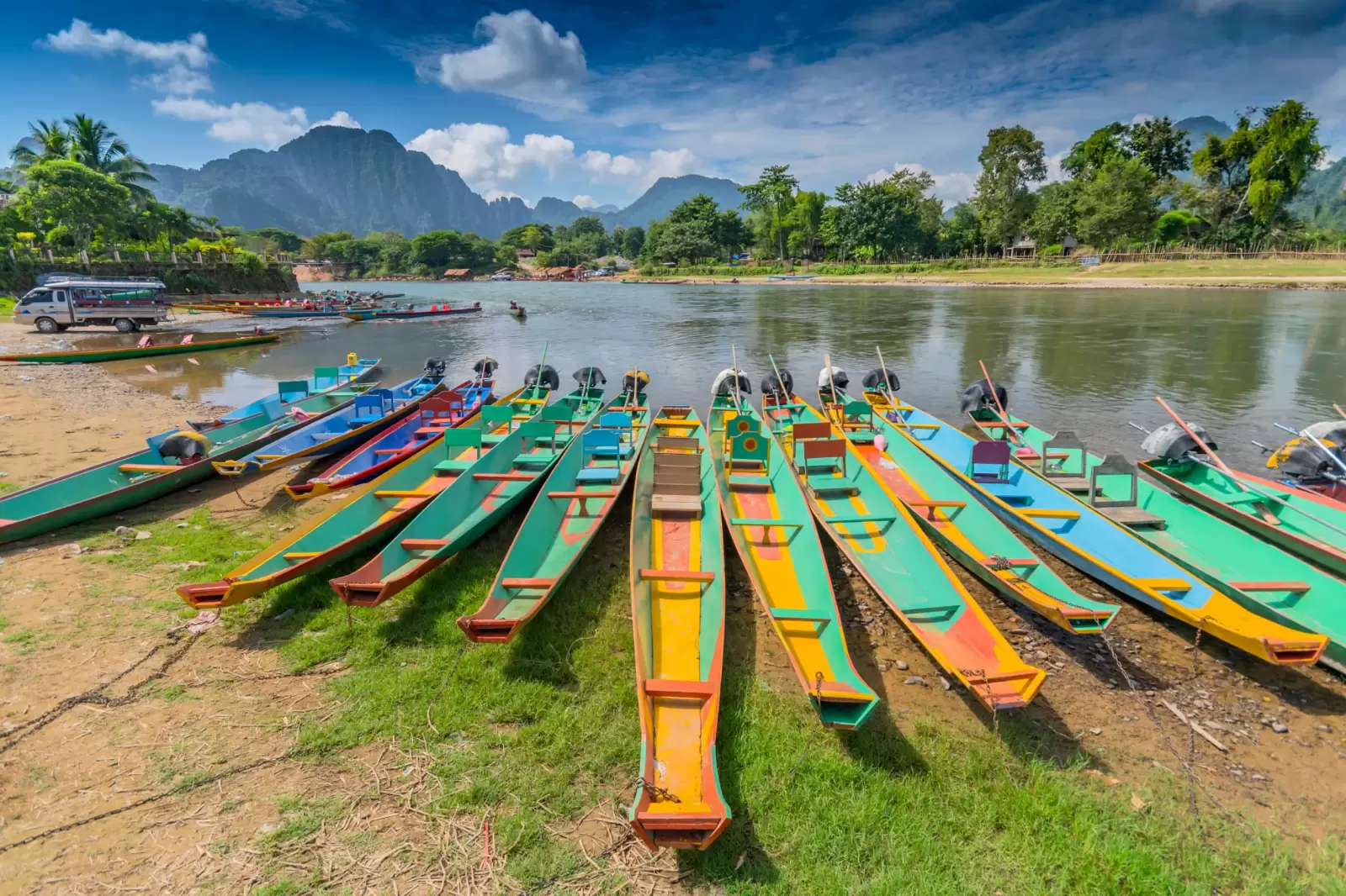 long tail boats on song river in vang vieng laos long tail boats on song river in vang vieng laos