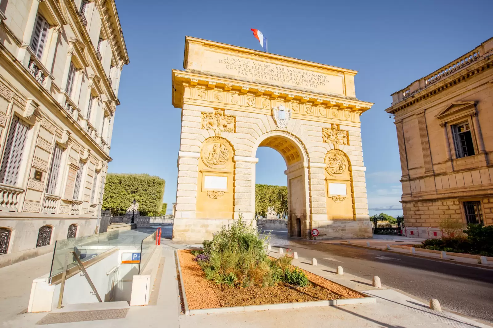 view with famous triumphal arch on the foch boulevard during the morning light in montpellier view with famous triumphal arch on the foch boulevard during the morning light in montpellier
