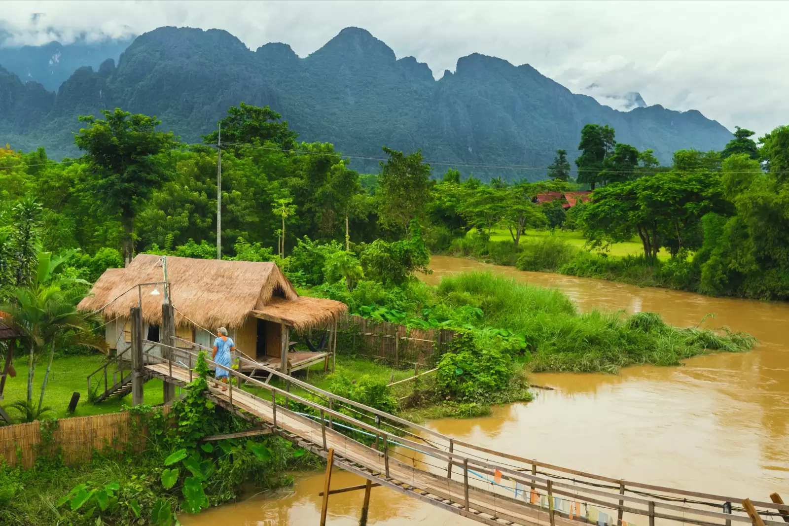 village hut near river in vangvieng laos village hut near river in vangvieng laos